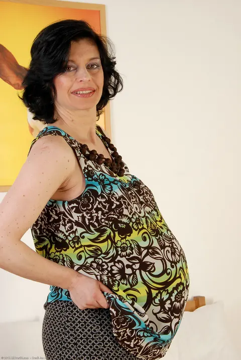 Pregnant MILF with Curly Short Hair Undresses and Spreads – photo 4 of 21