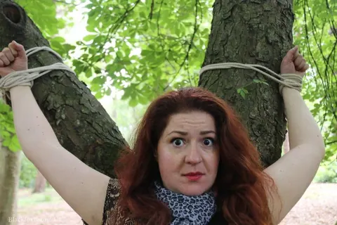 Redhead Bound to a Tree in a Forest Wearing a Skirt – photo 4 of 16