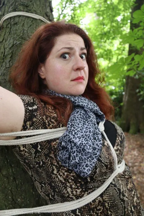 Redhead Bound to a Tree in a Forest Wearing a Skirt – photo 5 of 16