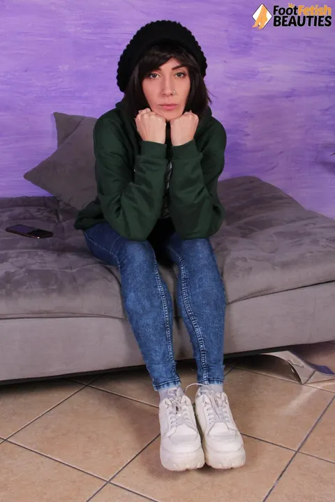 European Brunette Shows Her Feet in Jeans and Socks – photo 1 of 12