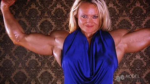 Brigita Brezovac: Blonde MILF Flexes Her Muscles in a Dress at the Gym – photo 19 of 21