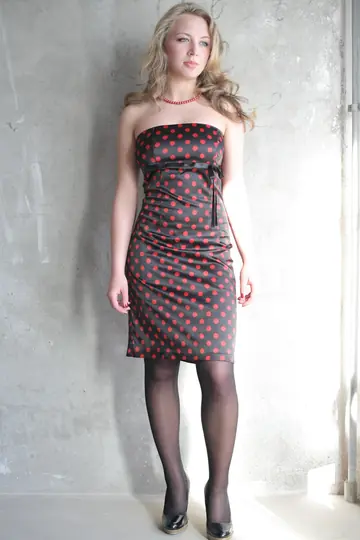 Curly Babe in a Dress and Stockings Shows Off Her Big Tits