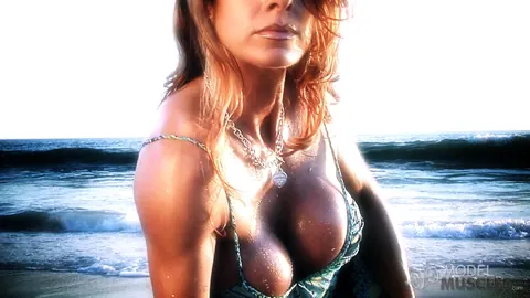 Busty Bodybuilder Flexes Her Muscles and Shows Cleavage on the Beach – photo 12 of 21