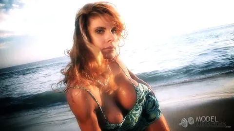 Busty Bodybuilder Flexes Her Muscles and Shows Cleavage on the Beach – photo 18 of 21