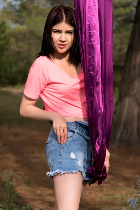 Lolly J: Petite Brunette Strips Out of Her Shorts Outdoors by a Purple Rope – photo 5 of 21