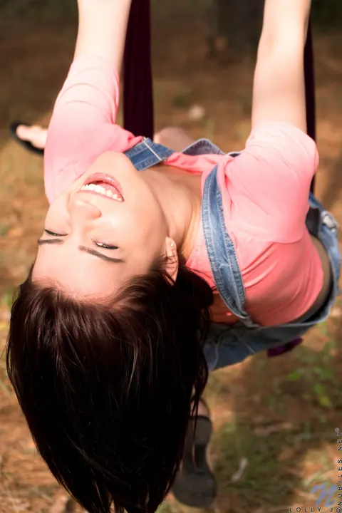 Lolly J: Petite Brunette Strips Out of Her Shorts Outdoors by a Purple Rope – photo 2 of 21