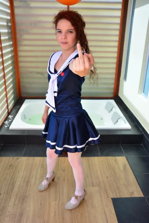 Yenny Contreras: Latina Redhead Flips the Bird and Teases in Uniform Outdoors – photo 8 of 16
