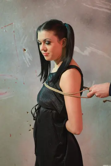 Woman in Pigtails and Glasses Tied Up in Stockings and Boots