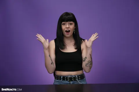 Lily Lane: Brunette with Enhanced Tits and Tattoo Reacts While Clothed – photo 15 of 21