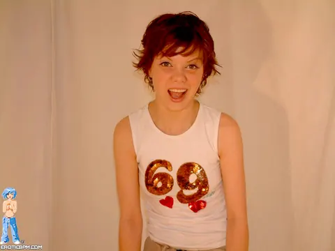 Redhead with Piercings Fingers Herself in a Skirt – photo 2 of 15