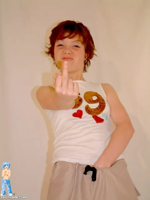 Redhead with Piercings Fingers Herself in a Skirt – photo 3 of 15