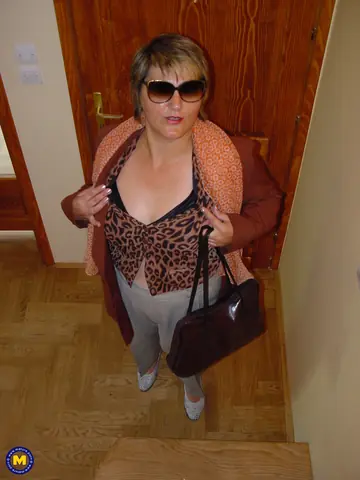 Chubby Mature Woman in Glasses Strips Nude and Shows Her Hairy Pussy