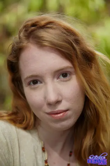 Busty Pale Redhead Wades into a Stream in a Skirt