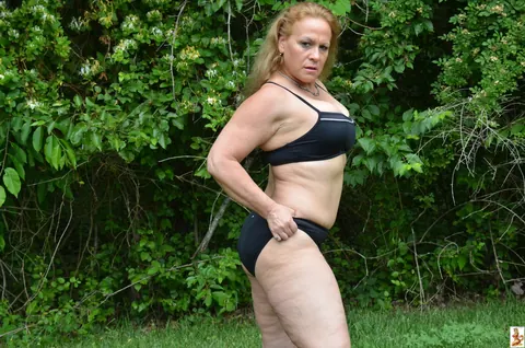 Stunning Summer: Mature Blonde with Big Tits Poses in a Skirt Over Shorts Outdoors – photo 10 of 15
