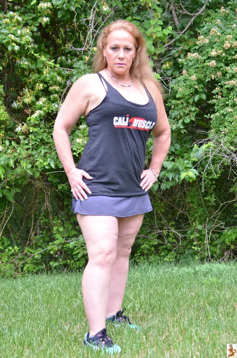 Stunning Summer: Mature Blonde with Big Tits Poses in a Skirt Over Shorts Outdoors – photo 7 of 15