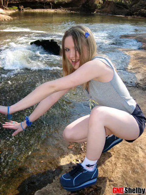 Amateur Woman in Shorts Flashes Her Tits by a Stream – photo 2 of 12