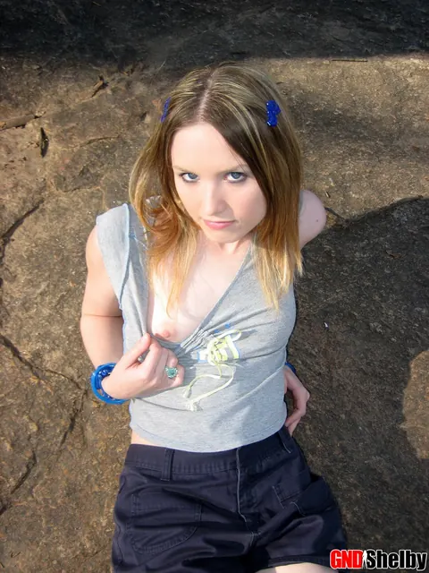 Amateur Woman in Shorts Flashes Her Tits by a Stream – photo 11 of 12