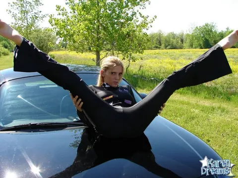 Busty Blonde Poses in a Jumpsuit on the Car Hood Outdoors – photo 5 of 12