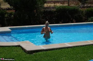 Blonde MILF Goes Skinny Dipping in the Pool by Day