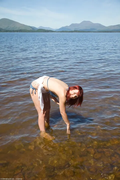 Tall Redhead MILF Strips Out of Her Bikini on the Beach – photo 2 of 21