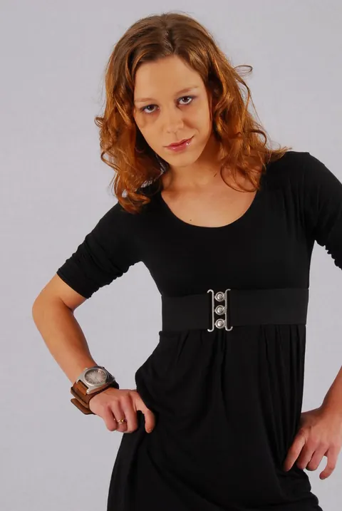 Redhead in a Skirt Over Jeans Poses with a Cuff Watch – photo 13 of 16