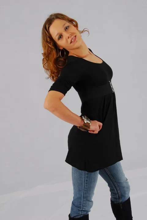 Redhead in a Skirt Over Jeans Poses with a Cuff Watch – photo 12 of 16