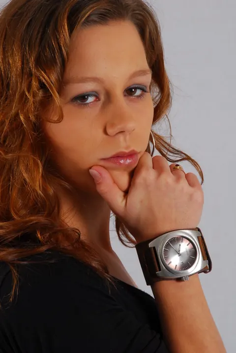 Redhead in a Skirt Over Jeans Poses with a Cuff Watch – photo 3 of 16