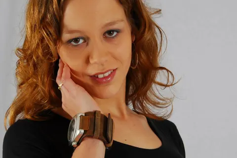 Redhead in a Skirt Over Jeans Poses with a Cuff Watch – photo 8 of 16