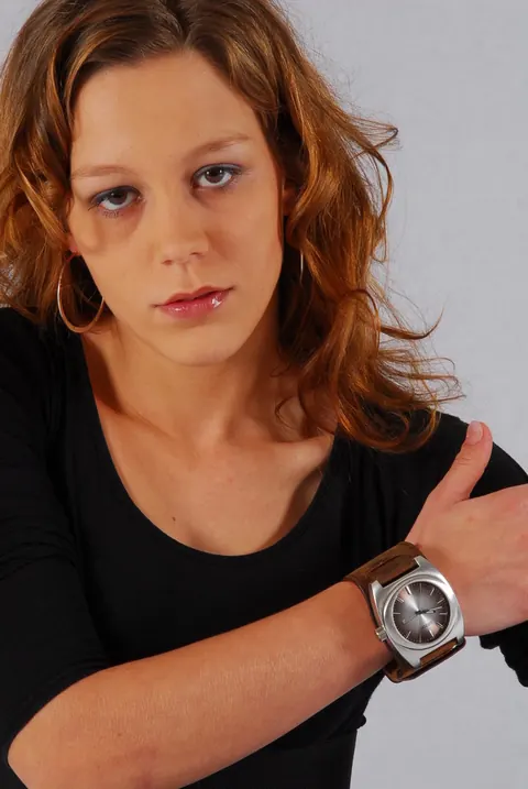Redhead in a Skirt Over Jeans Poses with a Cuff Watch – photo 16 of 16