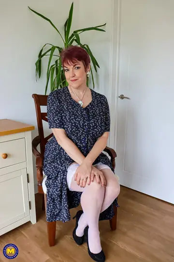 Mature Redhead in Lingerie and Stockings Fingers Her Pussy