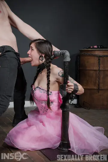 Slim Tattooed Brunette Gives a Blowjob in Bondage