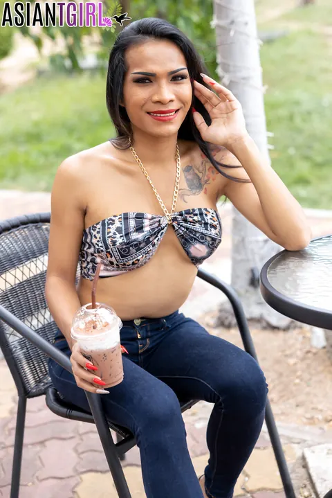 Asian Trans Woman in Jeans Kisses Her Partner – photo 1 of 16