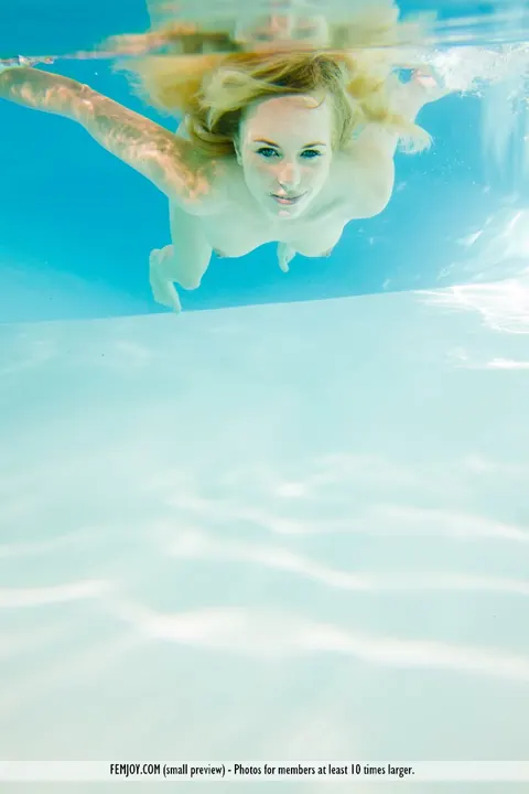 European Blonde Strips and Spreads Her Shaved Pussy by the Pool – photo 15 of 16