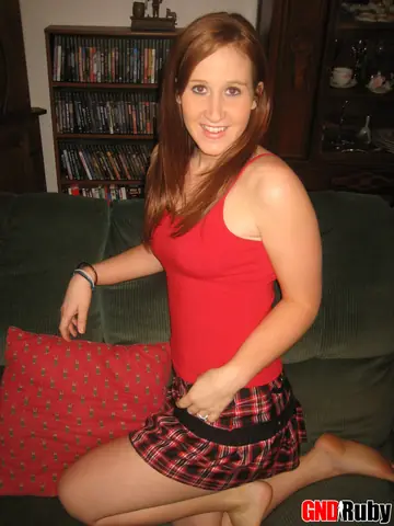 Redhead Lifts Her Skirt and Spreads on the Sofa