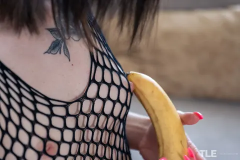Pollie Starr: Tattooed Brunette in Fishnet Bodysuit Masturbates with a Banana – photo 4 of 12