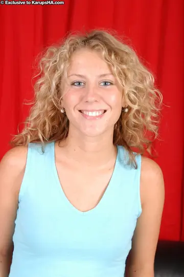 Curly Blonde Lifts Her Skirt and Spreads Her Shaved Pussy