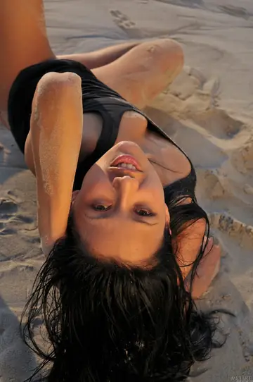 Brunette Spreads Her Shaved Pussy and Ass on the Beach