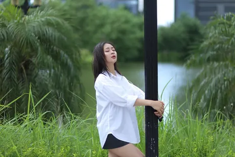 Asian Woman Strips Out of Her Shorts and Top Outdoors – photo 6 of 21