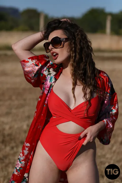 Valis Volkova: Curly Brunette with Big Tits Pulls Red Bikini Aside Outdoors – photo 4 of 21