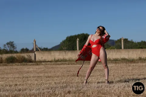 Valis Volkova: Curly Brunette with Big Tits Pulls Red Bikini Aside Outdoors – photo 5 of 21