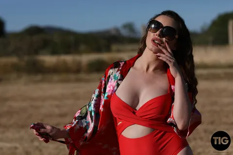 Valis Volkova: Curly Brunette with Big Tits Pulls Red Bikini Aside Outdoors – photo 3 of 21