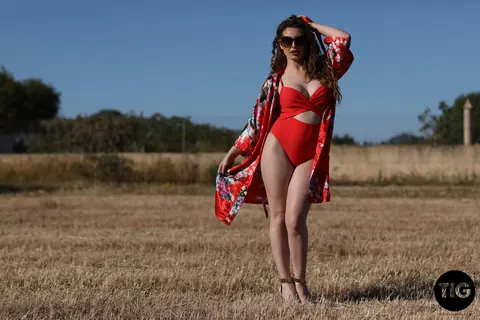 Valis Volkova: Curly Brunette with Big Tits Pulls Red Bikini Aside Outdoors – photo 1 of 21