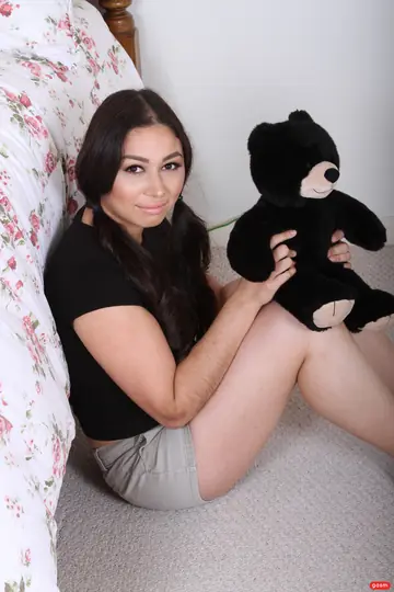 Woman with Pigtails Strips Off Her Top to Show Her Natural Tits