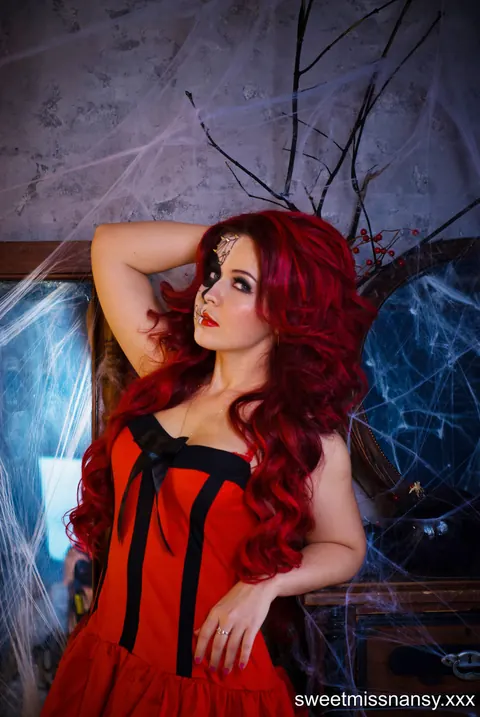 Curly Redhead in Glasses Poses in a Red Halloween Dress Outdoors – photo 7 of 15