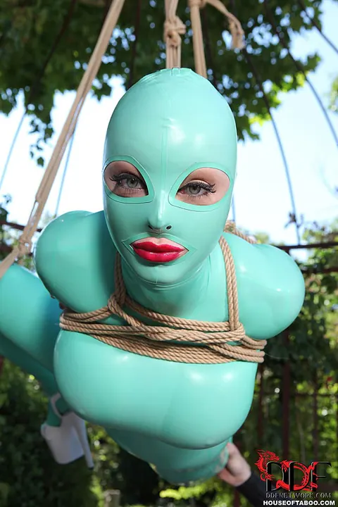 Latex Lucy: Busty Blonde MILF Suspended in Latex and Heels Outdoors – photo 5 of 16