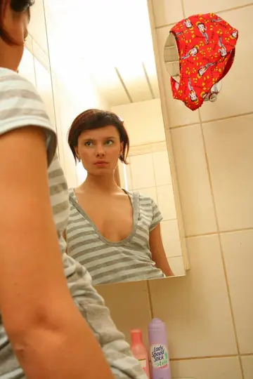 Naked Woman Shows Her Round Ass and Shaved Pussy