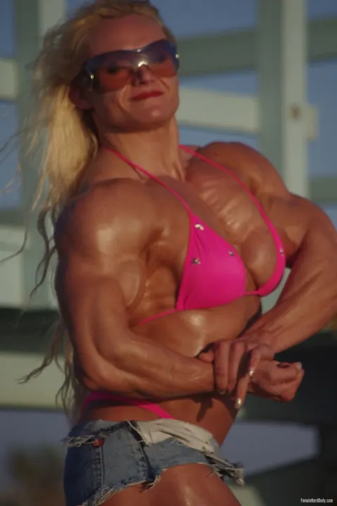 Brigita Brezovac: Thick Blonde MILF Flexes in a Bikini, Jeans, Shorts and Glasses on the Beach – photo 3 of 20