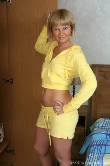Short-Haired Mature Blonde Strips and Spreads Her Hairy Pussy in the Bedroom