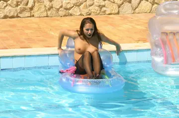 Brunettes in Bikinis and Stockings Kiss by the Pool