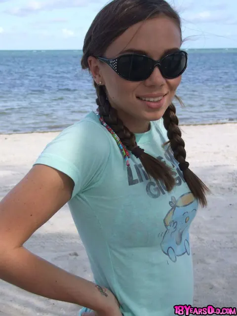 Alexis Capri: Brunette in a Bikini and Shorts Spreads Her Legs on the Beach – photo 1 of 16